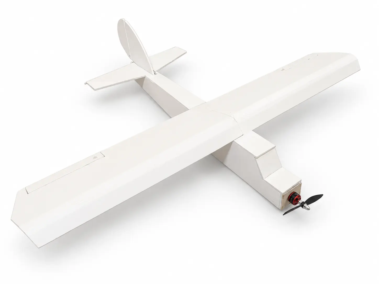 Completed ultralight foam-board RC aircraft with custom wing, fuselage, and tail geometry.