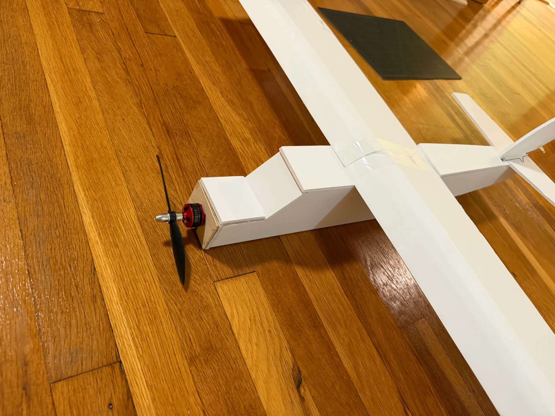 Close-up of the aircraft nose showing the propeller and motor installation.