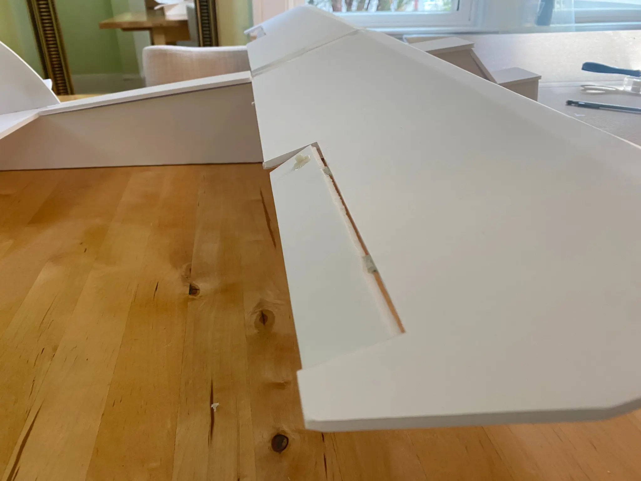 Close view of a hand-cut aileron and formed foam-board wing profile.