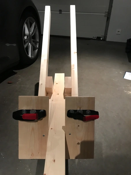 Wooden angled footplates with red and black Velcro foot straps.