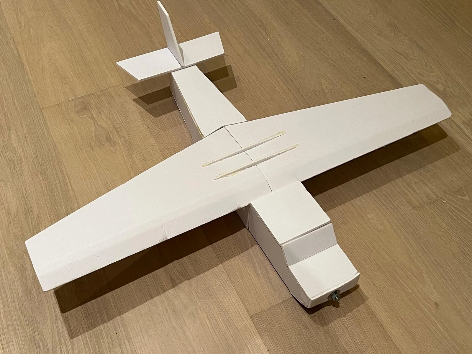 Second glider aircraft build, photographed from above with the white wing, fuselage, and tail visible.